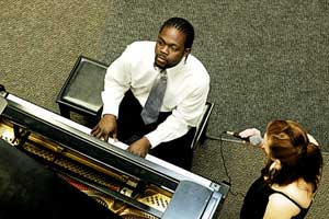 PHOTO: Carlton Jay plays piano as Kelsey Byrne sings