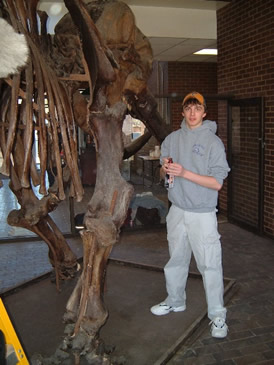 Photo: Biology student and mastodon skeleton