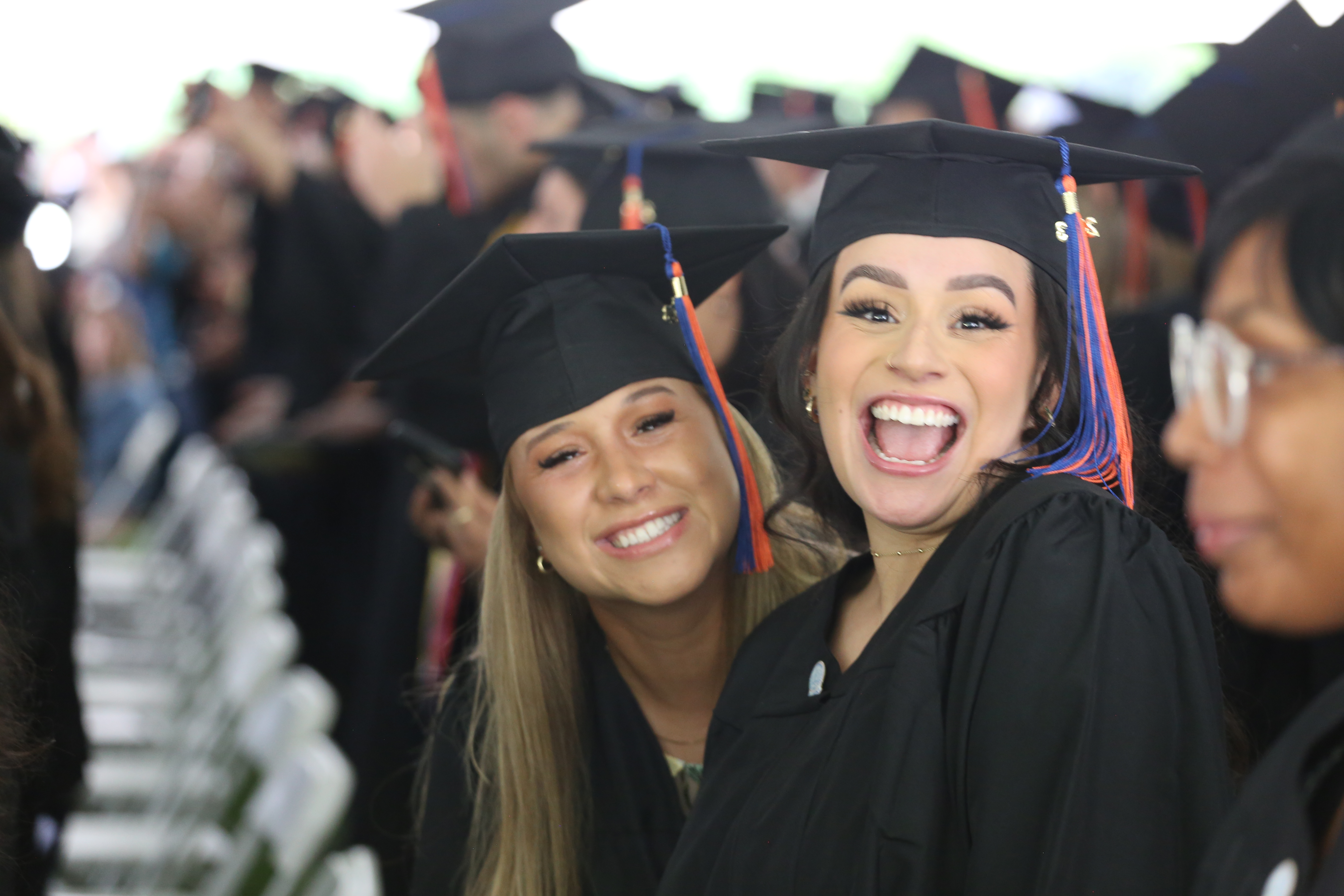 students smiling for camera during commencement