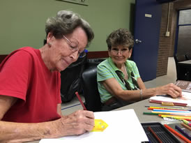 Two students busy at drawing.