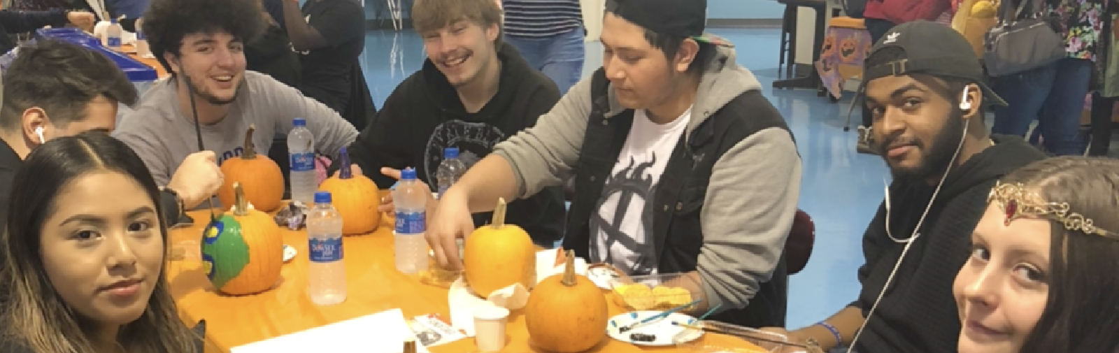 students painting pumpkins