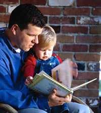 Photo: Man reading to child