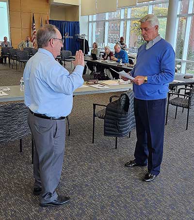 Nicholas Illobre completes his oath of office.