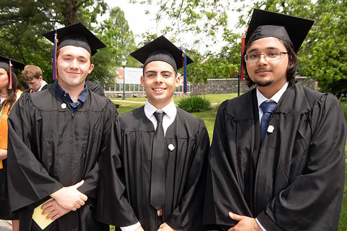Three smiling grads