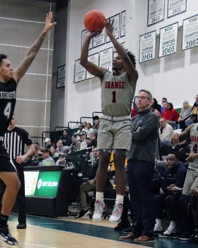 marquis gill shoot three point jumpshot with coach tom rickard looking on.