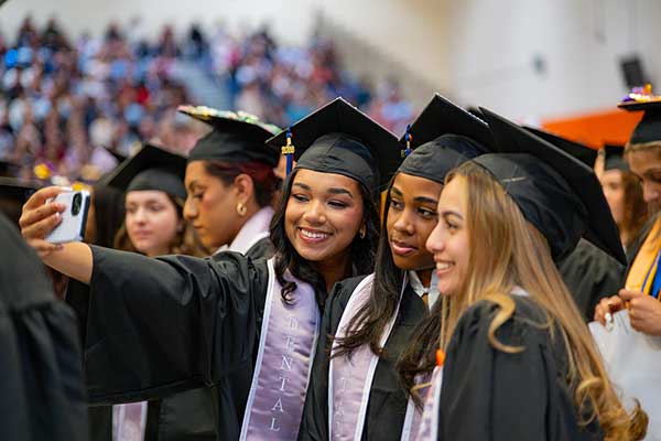 2026 grads take a smiling selfie