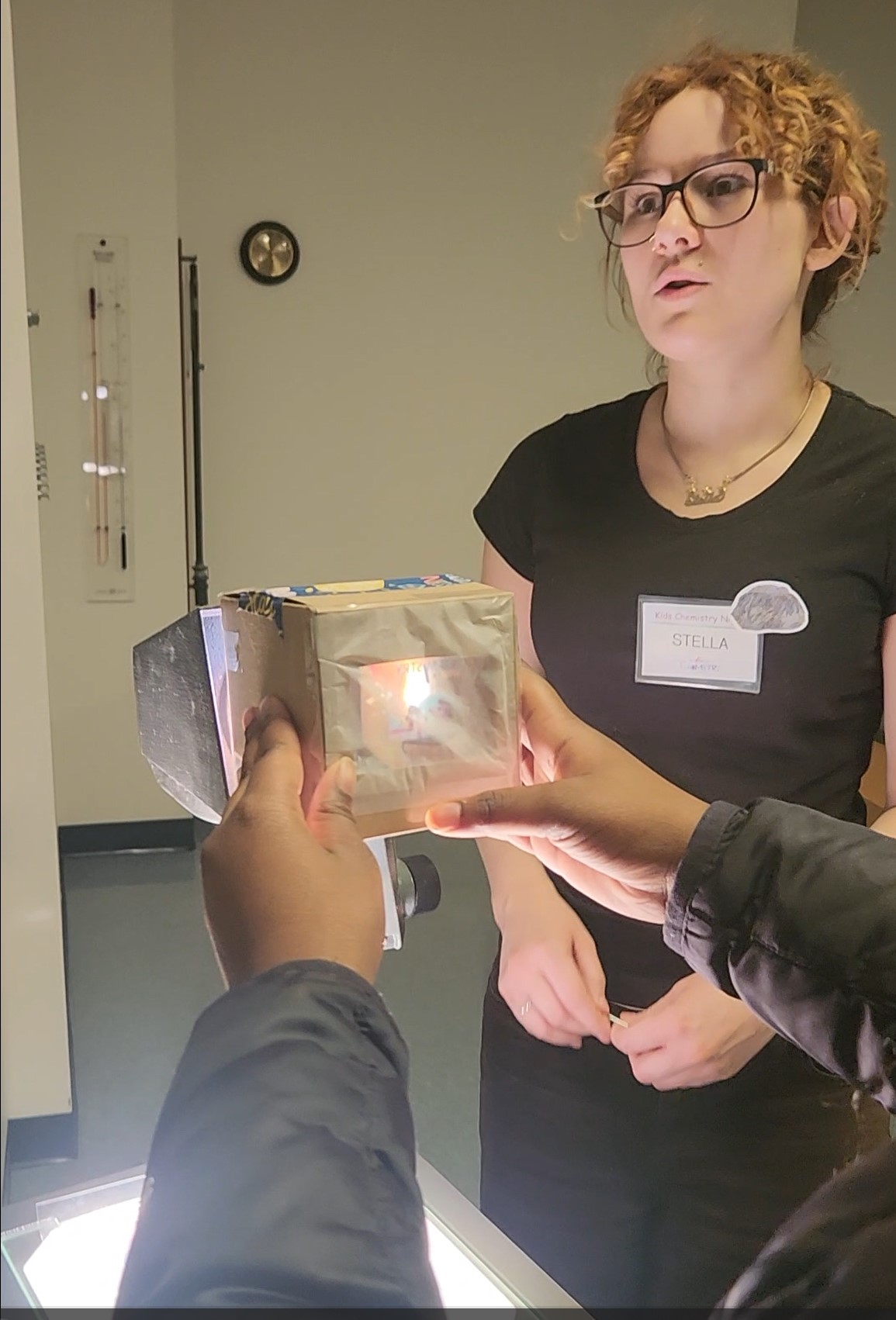 Stella Page explaining pinhole projection to kids. 